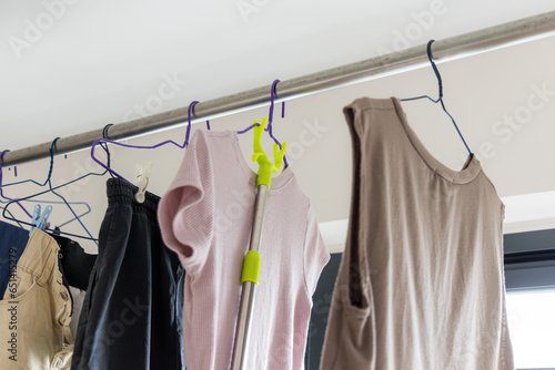 Dry laundry clothes and hanging up in indoor