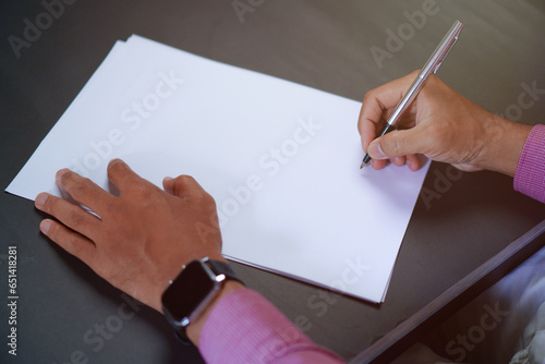Man Holds a Pen and Ready to Write on Sheets of Paper  Writing Letter Concept 