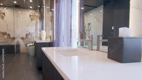 Modern Tiled Bathroom with Shower in modern home, real estate interior. Wide footage. Move camera photo
