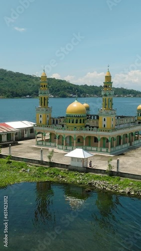 Aerial view of Linuk Masjid a mosque beside the Lake Lanao in Lanao del Sur. Mindanao, Philippines. Vertical view. photo