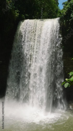 Aerial view of waterfall in Lake Sebu. Falls surrounded by lush vegetation and towering mountains. Mindanao, Philippines. Vertical view. photo