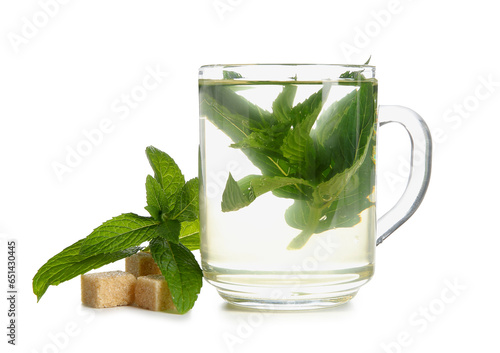 Cup of fresh mint tea with cane sugar isolated on white background