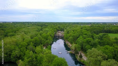 Aerial Forward Tilt Down Shot Of Floating Platforms In Pond Amidst Trees Against Sky - Crawfordsville, Indiana photo