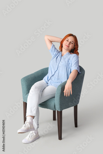 Young woman sitting in soft...