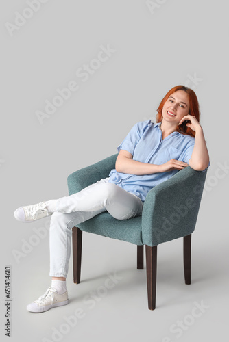 Young woman sitting in soft...