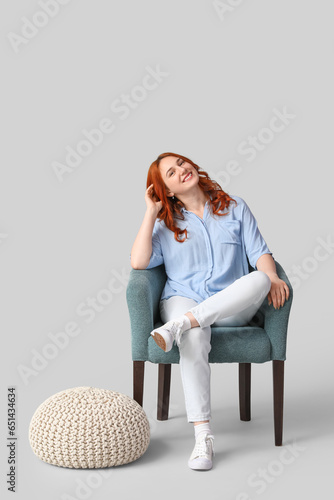 Young woman sitting in soft...