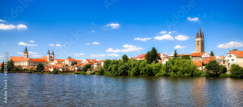Panoramic View of Beautiful Telc at the Lake Ulicky Rybnik in the Czech Republic, with Towers of the Name of Jesus Church, the Church of St James, and the Church of the Holy Spirit