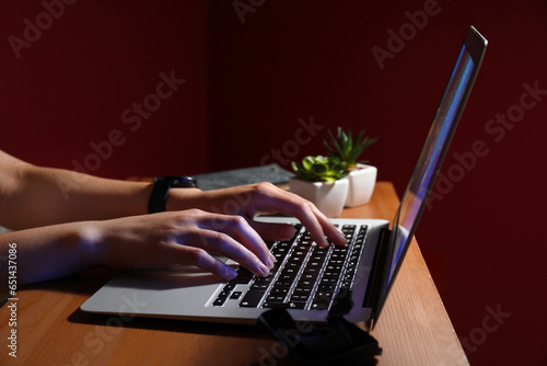Person typing on laptop key...