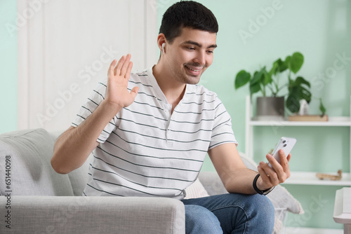 Young man with mobile phone...