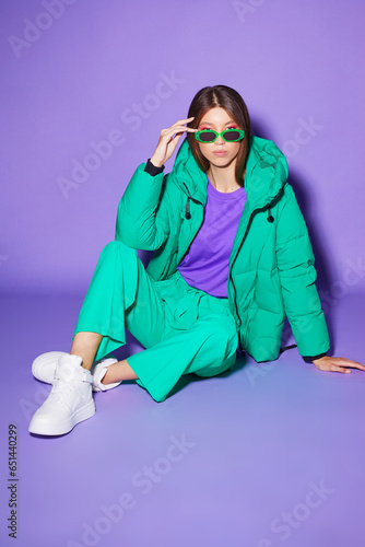 Fashion asian female model in green down jacket and pants.