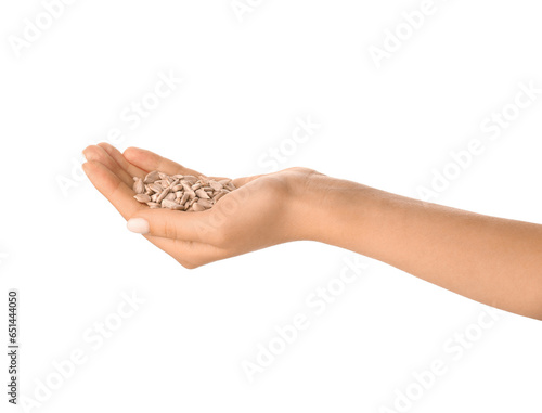 Woman holding sunflower seeds on white background