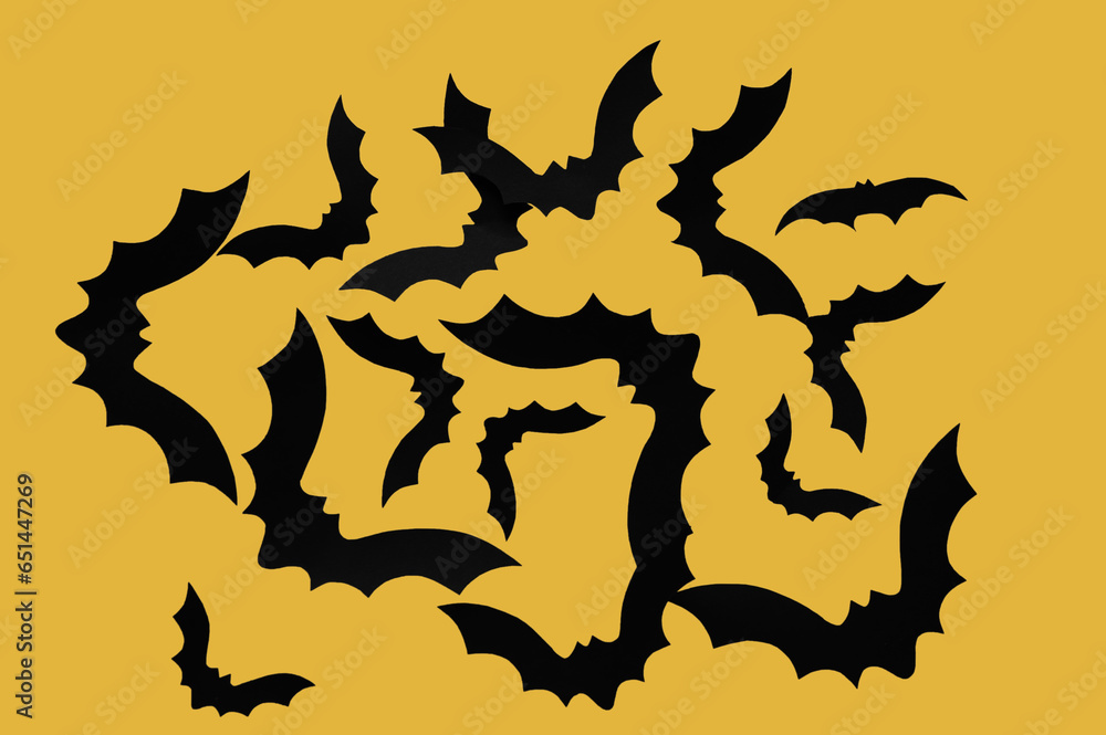 Paper bats for Halloween party on yellow background Paper bats for Halloween party on yellow background