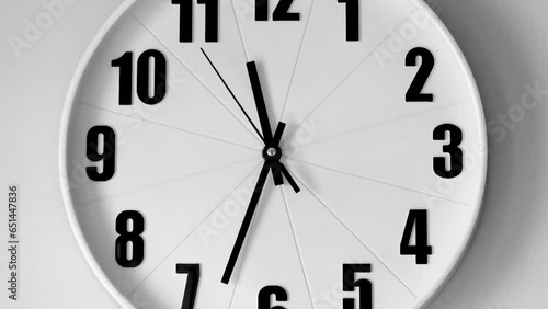 Close up to a wall clock, with running time pointer. 