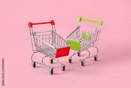 Shopping carts on pink background
