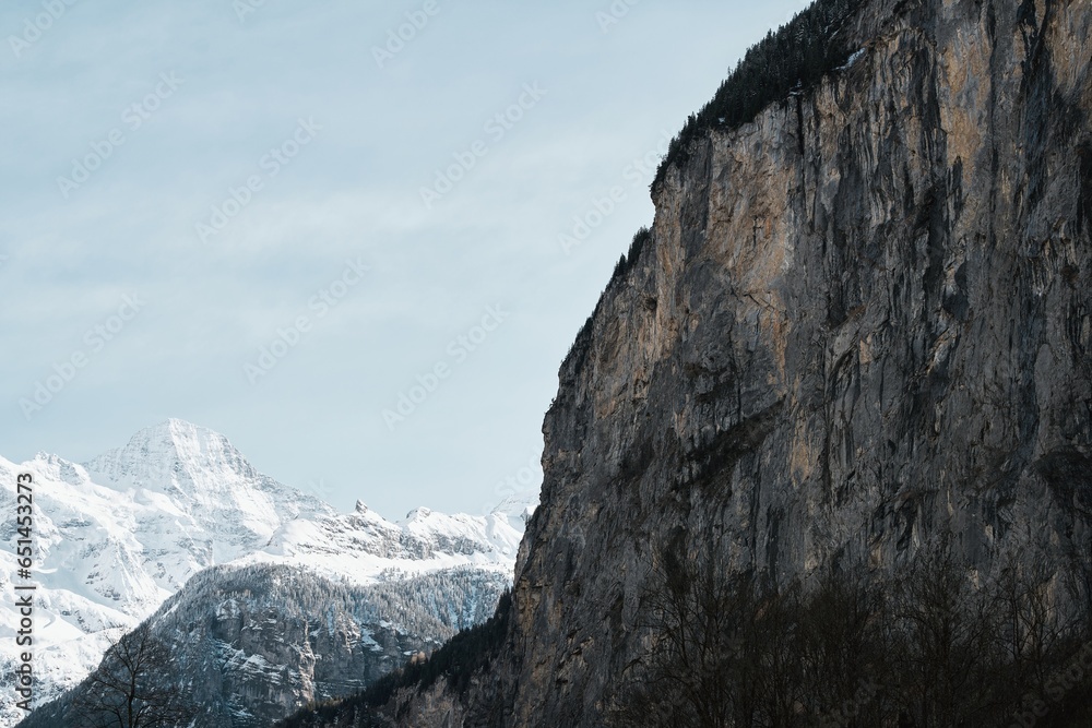 Grindelwald, Switzerland village and mountain Swiss Alps view panorama landscape, wooden chalets on green fields and high peaks in background, Bernese Oberland, Europe