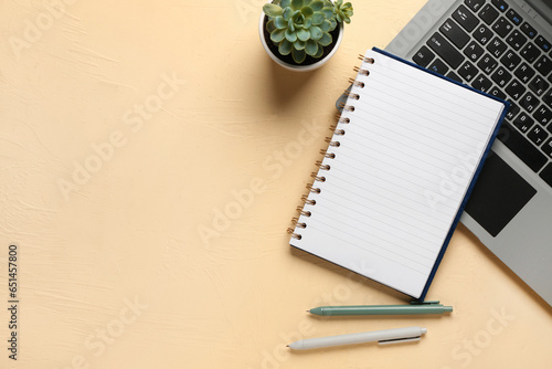 Notebook with pens and lapt...