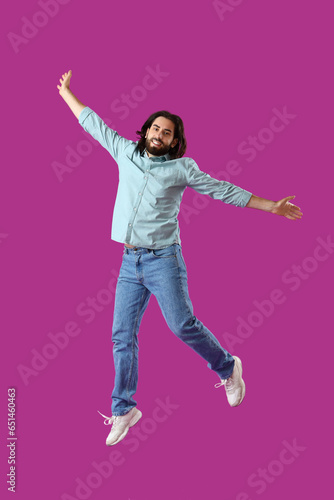 Jumping bearded young man o...