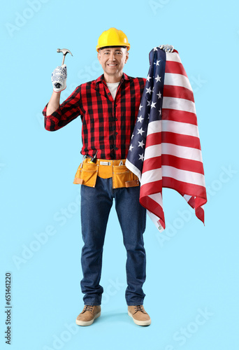 Mature worker with hammer a...