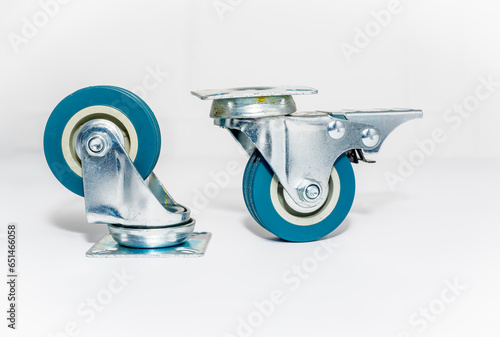 pair of furniture steel roller castors one with brake isolated on a white background 2 inch