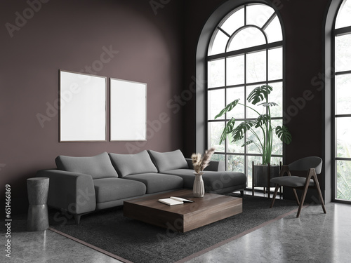 Brown living room corner with sofa and posters