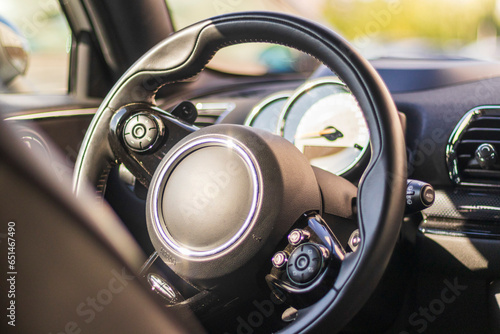 Close up shot of the steering wheel of the car. Concept