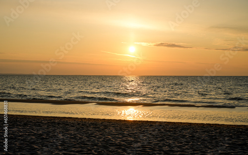 Sunset on the Baltic Sea in Poland. Landscape in the evening with setting sun by the sea. © Elly Miller