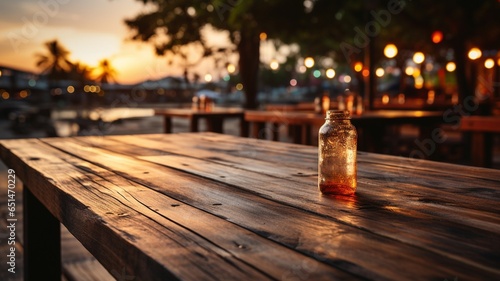 Wooden table top with blurry beach cafés in the backdrop at dusk - suitable for montaging or displaying your goods.