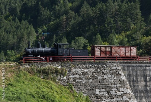 Jablanica, Bosnia and Herzegovina - Sep 18, 2023: Old Neretva Train Bridge. Memorial of the Battle on the Neretva, fought between Yugoslav partisans and Axis forces. Sunny summer day. Selective focus. photo