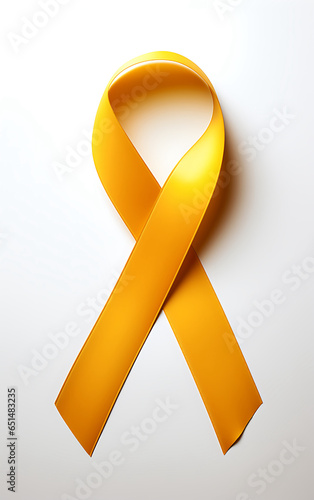 Una cinta amarilla de concientización sobre el cáncer aislada sobre fondo blanco photo