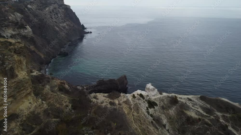 Aerial view on calm azure sea and volcanic rocky shores. Small waves on water surface. Nature summer ocean sea beach view. Nobody. Holiday, vacation and travel concept. Weather and climate change Aerial view on calm azure sea and volcanic rocky shores. Small waves on water surface. Nature summer ocean sea beach view. Nobody. Holiday, vacation and travel concept. Weather and climate change
