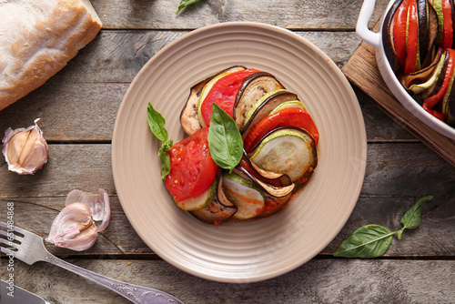 Plate of tasty Ratatouille on wooden background