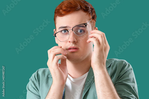 Fearful young man in eyegla...