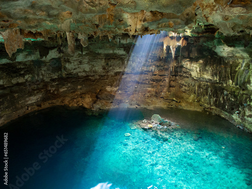 Cenote in Mexico with crystal clear, blue water (cave)
