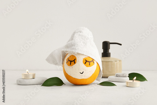 Papier peint Pumpkin with mask, spa stones and leaves on light background