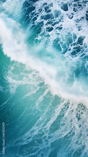 Spectacular aerial top view photo of ocean sea water white wave splashing in the deep sea, captured from a bird's - -eye perspective. The drone photo backdrop of the sea wave highlights its power 
