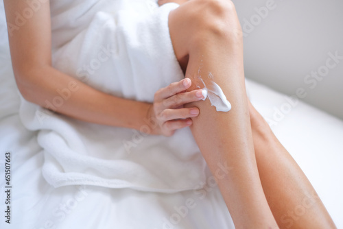 Woman applying natural cream, Woman moisturizing her leg with cosmetic cream, Spa and Manicure concept.