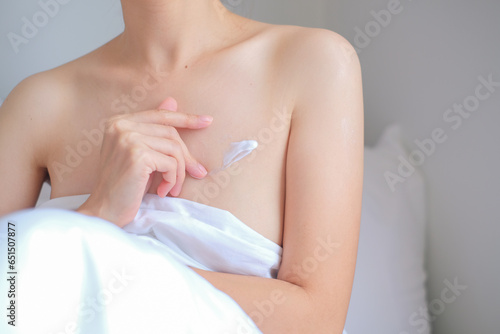 Woman applying natural cream, Woman moisturizing her chest with cosmetic cream, Spa and Manicure concept.
