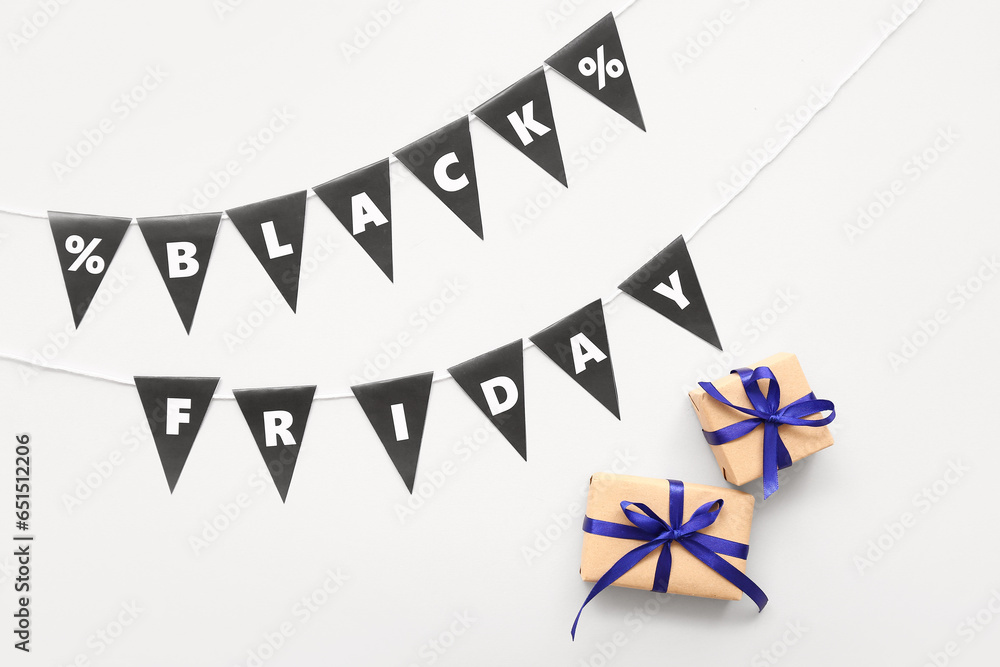 Obraz premium Gift boxes, rope, flags with text BLACK FRIDAY and percent signs on white background