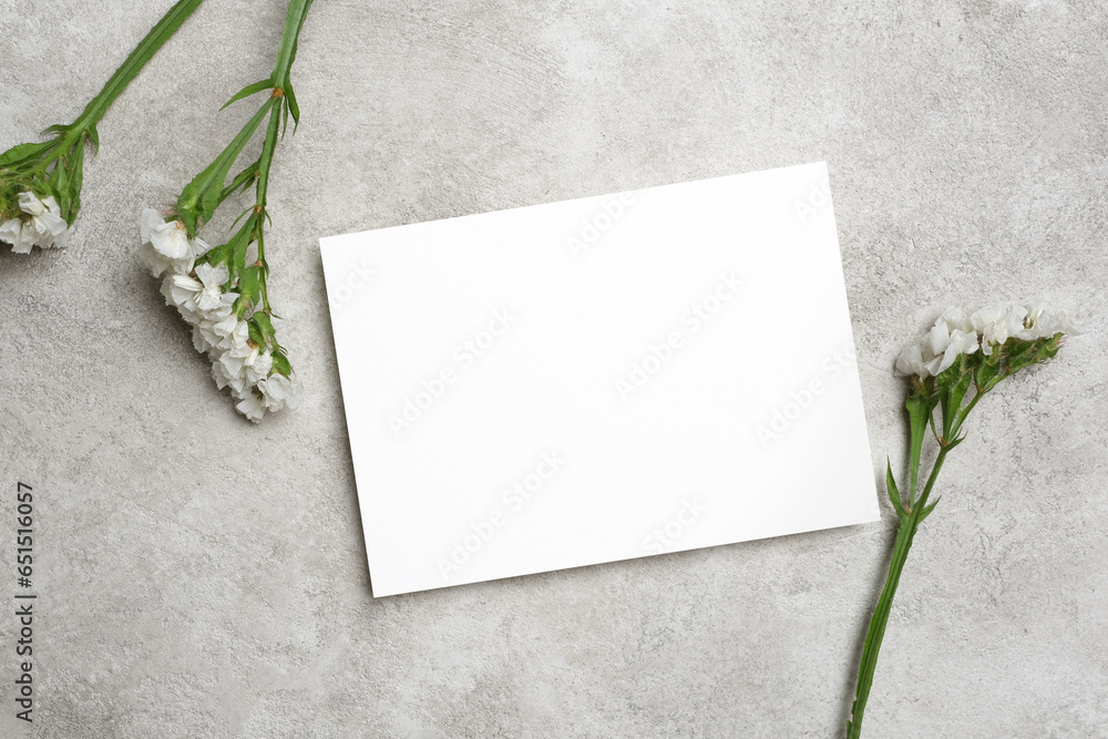 Blank invitation card mockup with white flowers, flat lay with copy space for card design Blank invitation card mockup with white flowers, flat lay with copy space for card design