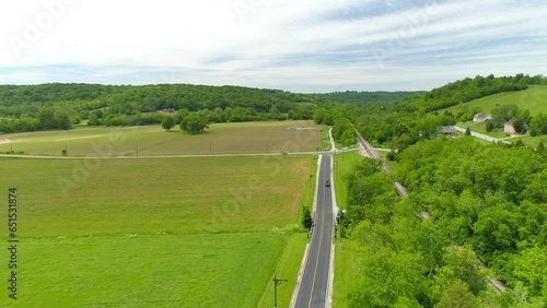 Aerial Descending Forward Shot Of Cars Moving On Roads By Railway Track Against Cloudy Sky - Crawfordsville, Indiana photo