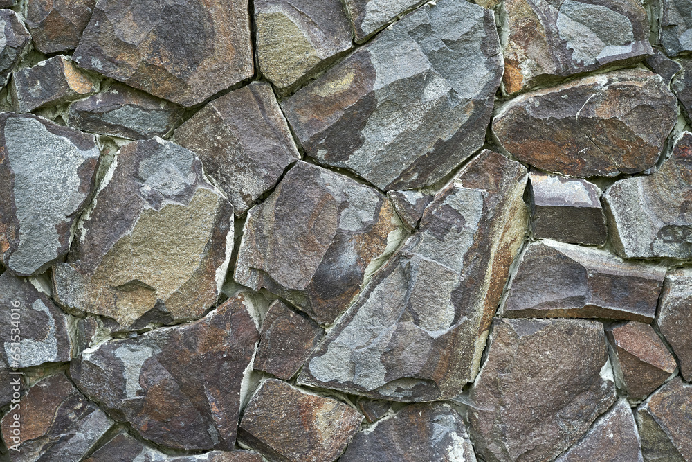 Fototapeta premium the wall is lined with natural stone texture