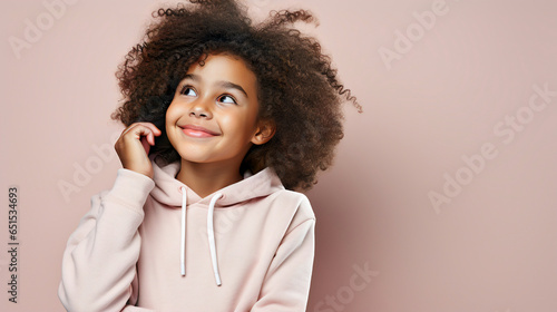 Young African American kid girl in casual clothes smiling, copy space. Cute child, Advert, Valentine day, Mother day, International Women Day