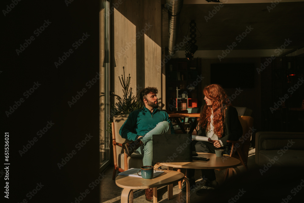 Front view photo of lovely business couple working together at the cafe on a beautiful sunny morning