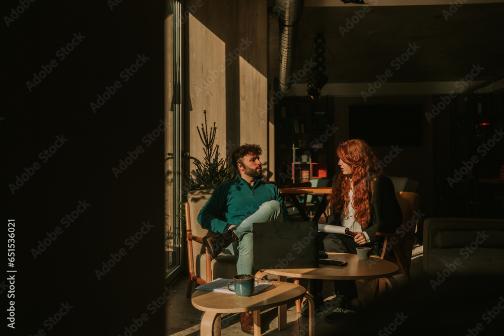 Front view photo of lovely business couple working together at the cafe on a beautiful sunny morning Front view photo of lovely business couple working together at the cafe on a beautiful sunny morning