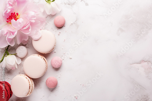 A close-up of a gourmet macaroon with delicate floral decorations on marble table.