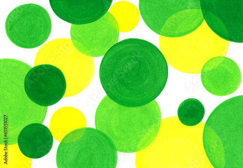 Artistic abstract background with hand painted green circles of different diameters. Acrylic, gouache or watercolor yellow, light green and dark green colors paint. Circle shape design elements.