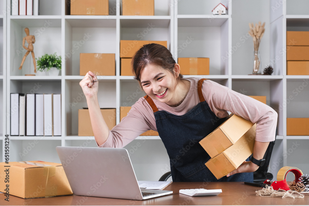 Successful small business shop owner celebrating her highert sell in the shop. Successful small business shop owner celebrating her highert sell in the shop.