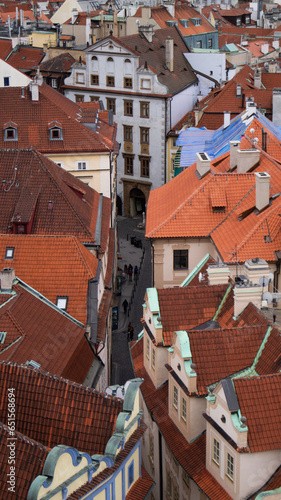 Narrow street from top view in old part of Prague, Czechia. Red roofs, nice old buildings, small people walking on the street. photo