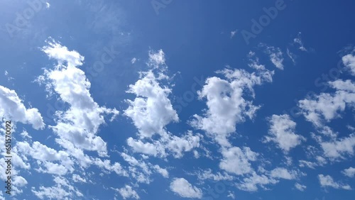 Differents clouds move in the illuminated blue sky at noon photo