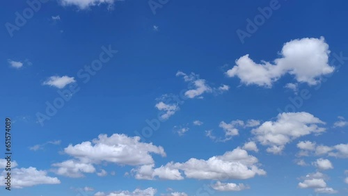 Landscape in the radiant sky with cumulus clouds moving at noon